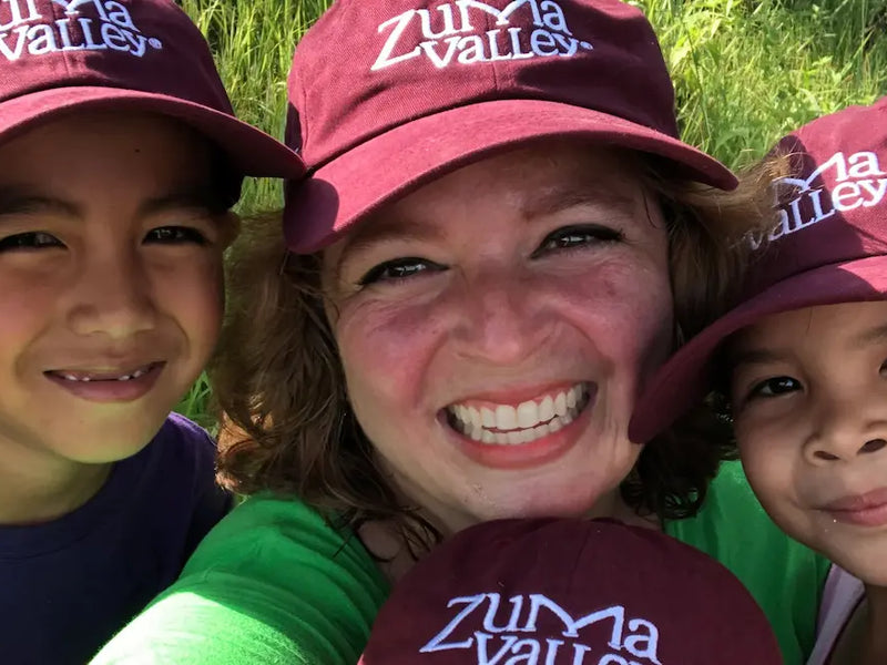 Smiling family with Zuma caps